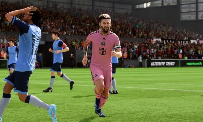 Lionel Messi in a pink Inter Miami kit running away after scoring.